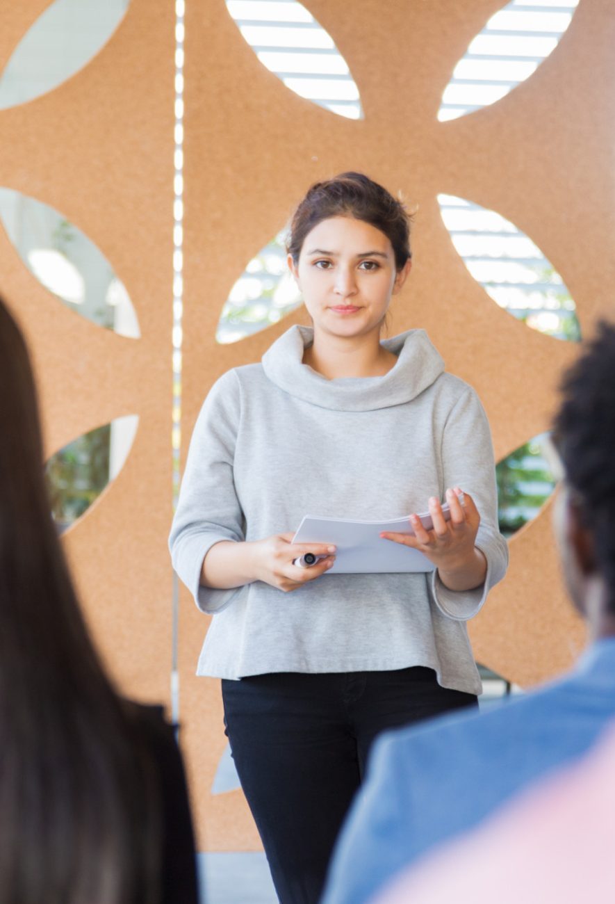 serious-female-woman-presenting-project-classmates